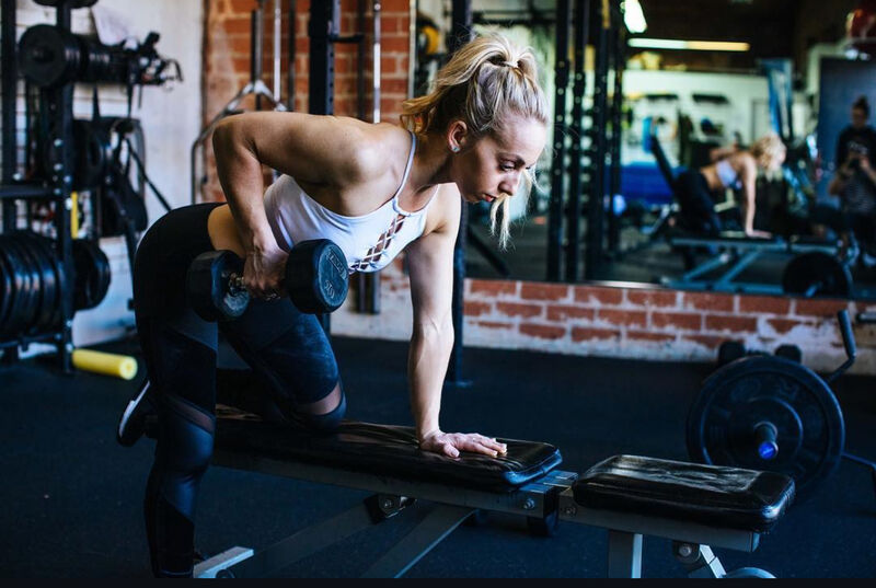 Katy demonstrating a dumbbell row in the studio